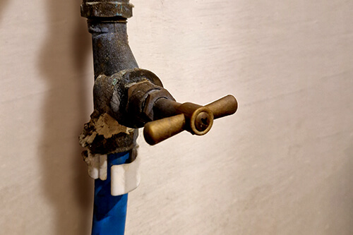 A stop tap inside a cupboard